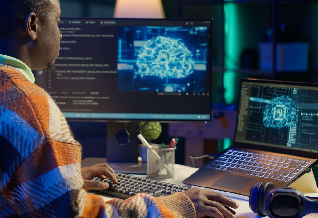 Black man working on laptop with AI tools
