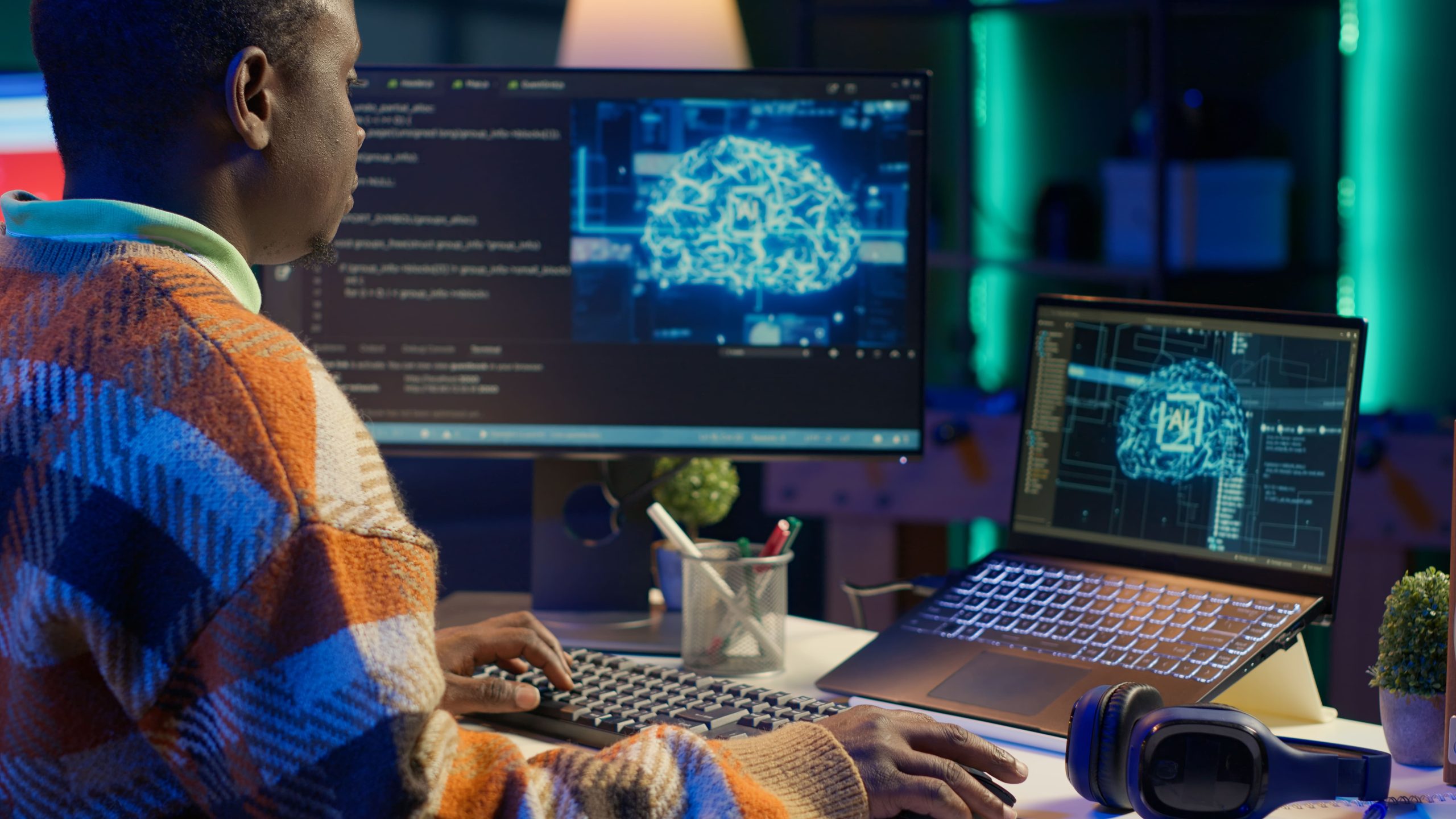 Black man working on laptop with AI tools